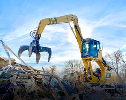 Excavator removing construction debris